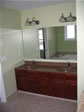 Oversized oak vanity with double sinks and were designed for this children’s hall bathroom 