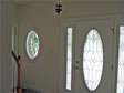 Full double sidelites surround this glass front door giving additional light into the foyer