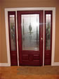 Three quarter wood stained glass front door with matching sidelite makes an elegant entry look