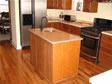 Oak kitchen cabinetry can be matched to surrounding hardwood floors for a uniform clean look