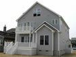 Double decks highlight the rear of this custom modular home by RBA Homes