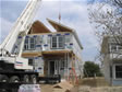 Crane placing the porch roof in place on the day of set on this Monmouth County, Oceanport, NJ modular home