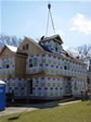 Section of a roof dormer being lowered and set into place on this 4 box modular home